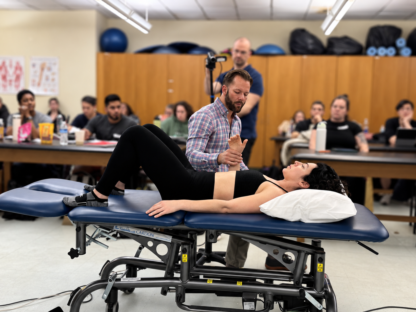 Dr. Sullivan demonstrating manual assessment to a classroom audience